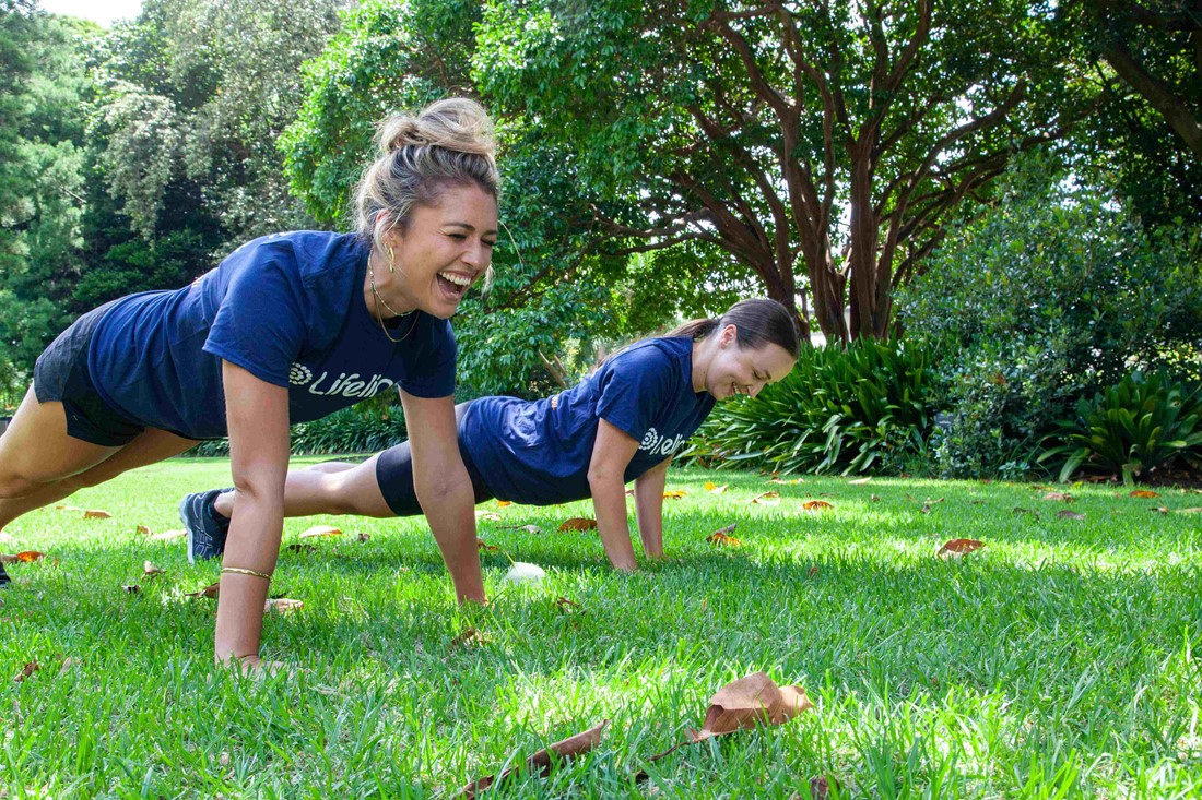 People doing pushups in the park